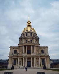 Low angle view of historical building against cloudy sky