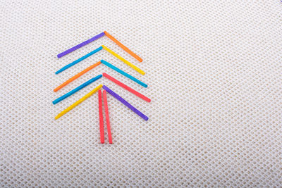 Directly above shot of multi colored pencils on table against white background