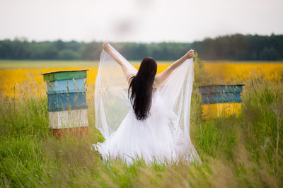 Woman with umbrella on field