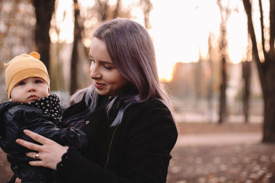 Woman with mother and daughter at home