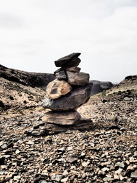 Low angle view of stack of rocks against sky