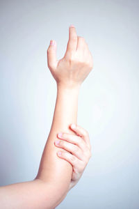 Close-up of woman hand over white background