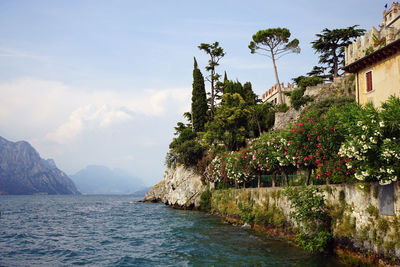 Scenic view of sea and mountains against sky