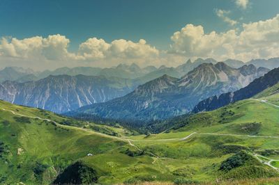 Scenic view of valley and mountains against sky