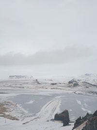 Scenic view of land against sky during winter