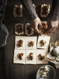 High angle view of hand holding food on table