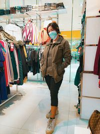 Full length portrait of woman at store