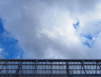 Low angle view of railing against sky