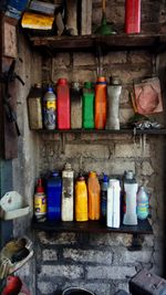 Multi colored bottles in shelf at kitchen