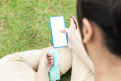 Midsection of woman using mobile phone