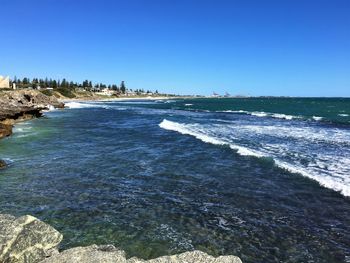 Scenic view of sea against clear blue sky