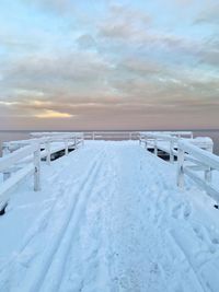 Scenic view of snow covered landscape against cloudy sky