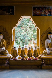 Statue of buddha in temple outside building