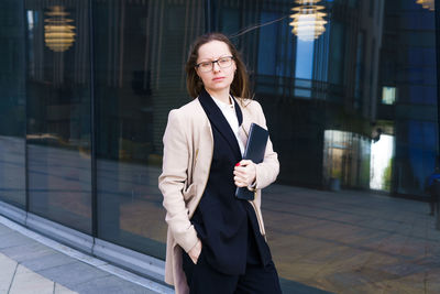 Business woman with a pensive look in glasses at the business center person