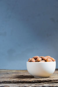 Close-up of salted almonds in bowl on table