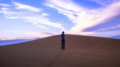 Silhouette of woman standing on landscape