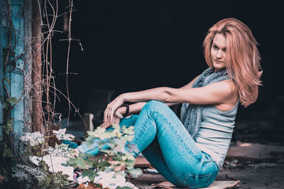 Beautiful young looking away woman sitting outdoors