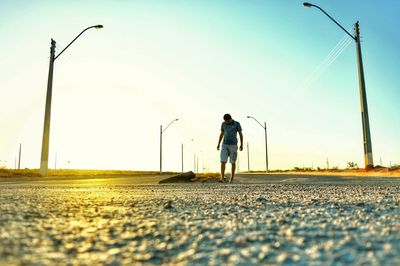 Man standing on field against clear sky