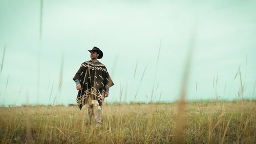 Rear view of man standing on field