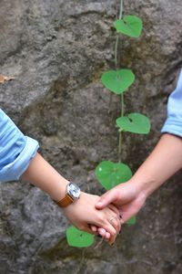 Midsection of couple holding hands