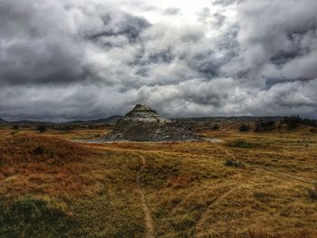 Scenic view of landscape against dramatic sky