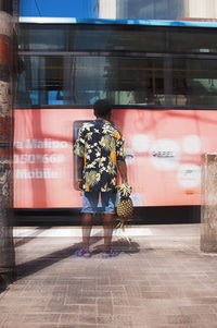 Rear view of person walking on street