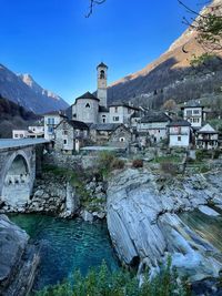 View of buildings by river in town in lavertezzo