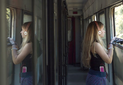 Side view of woman standing in corridor