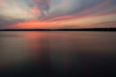 Scenic view of lake against romantic sky at sunset