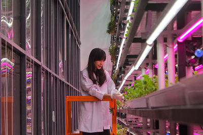 Dominique alexandra checking her indoor plants with the controlled environment agriculture system