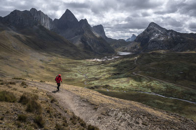 Full length of man walking on mountain against sky