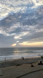 Scenic view of beach against sky during sunset