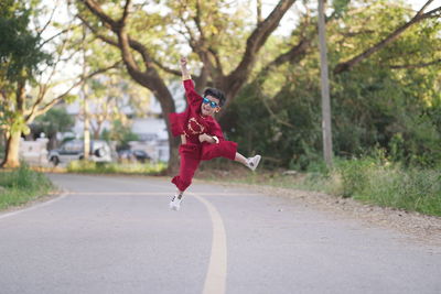 Full length of man jumping on road