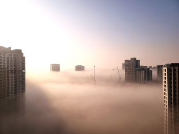 Modern buildings in city against clear sky