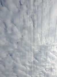 Low angle view of cables against sky