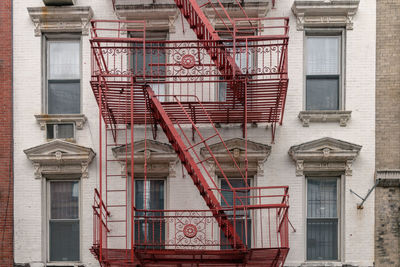 Low angle view of building in liwer manhattan with red metal fire escape.