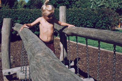 Shirtless girl at park on sunny day