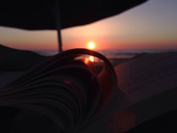 Close-up of open book at sunset