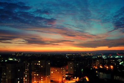 High angle view of illuminated buildings against sky at sunset