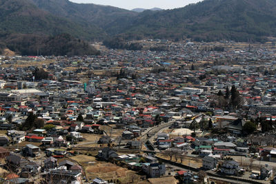 High angle view of townscape against mountains