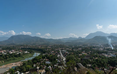 High angle view of townscape and mountains against sky