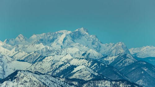 Scenic view of snowcapped mountains against clear blue sky