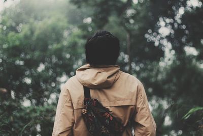 Rear view of man against trees