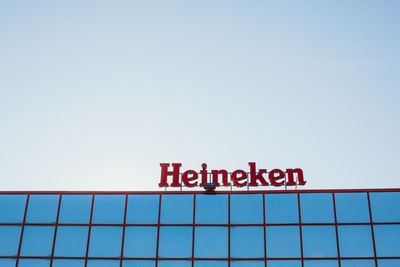 Low angle view of information sign against clear sky