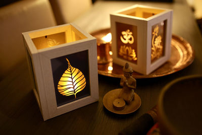 Close-up of illuminated lamp on table