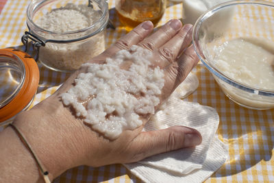 Cropped hand of person preparing food