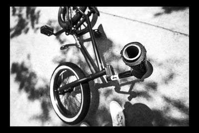 Low section of person with bicycle on street