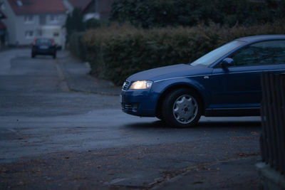 Close-up of car on road