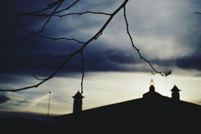 Silhouette of building against cloudy sky