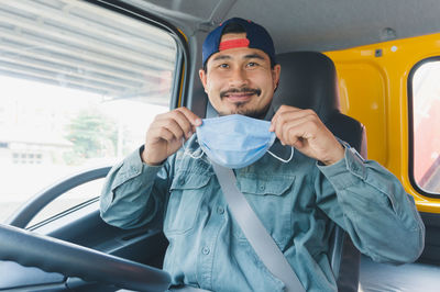 Portrait of man sitting in car